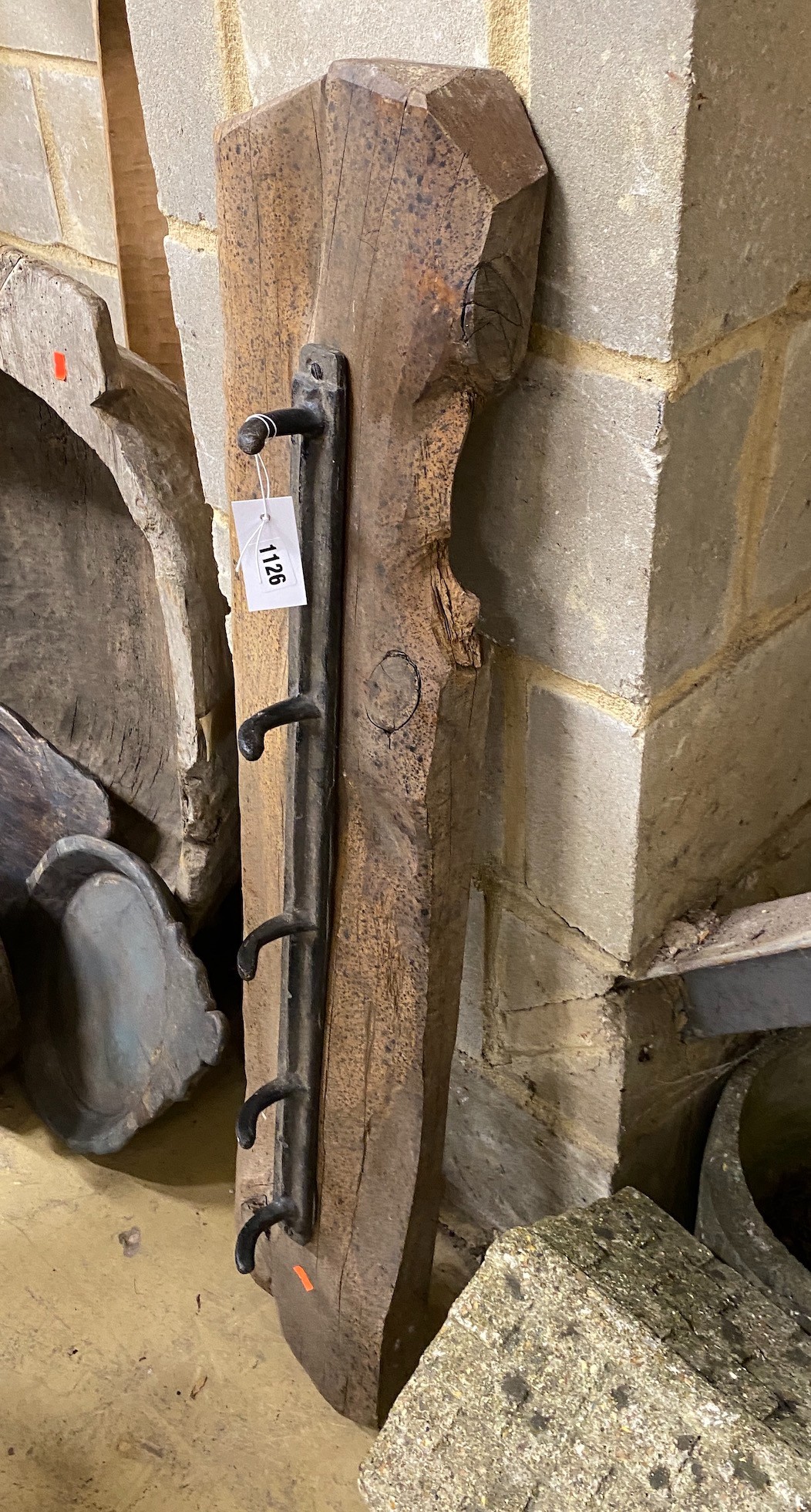 A provincial wrought iron and wood coat rack, width 107cm